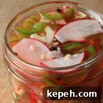 Spicy Mexican Pickled Radishes with Jalapeños and Lime 6 Close-up, top-view of Spicy Pickled Radishes with Jalapeños