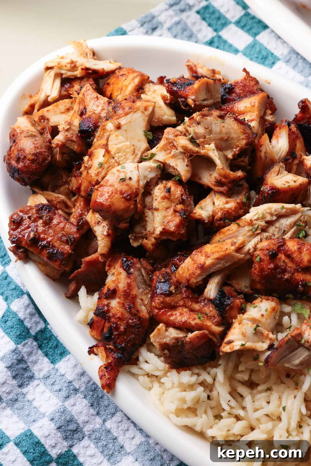 Sliced Chipotle chicken with rice Chopped Chipotle chicken served next to rice on a plate.