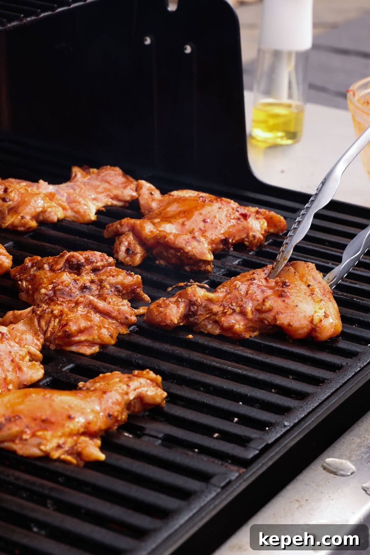 Grill the chicken until charred and cooked through. Chipotle chicken thighs on a grill.