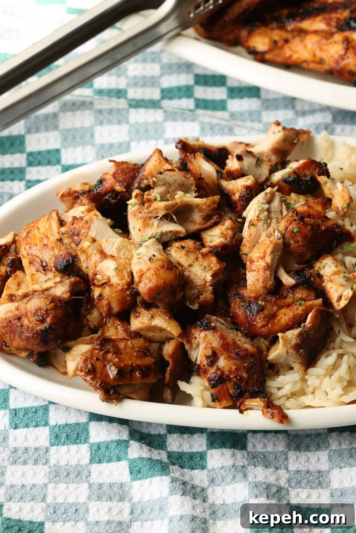 Serve Chipotle chicken with rice or bowls. Chopped Chipotle chicken served next to rice on a plate.