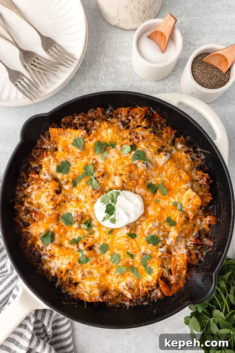Finished dish of beef enchilada skillet in cast iron skillet.