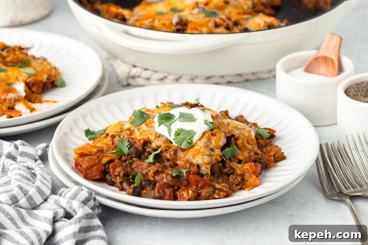 Ground beef enchilada skillet served on a white plate.