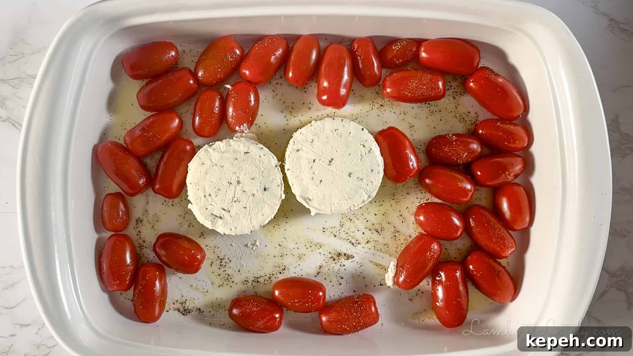 Creamy Boursin Pasta with Garlic and Herbs 4 boursin cheese and grape tomatoes in a casserole dish.