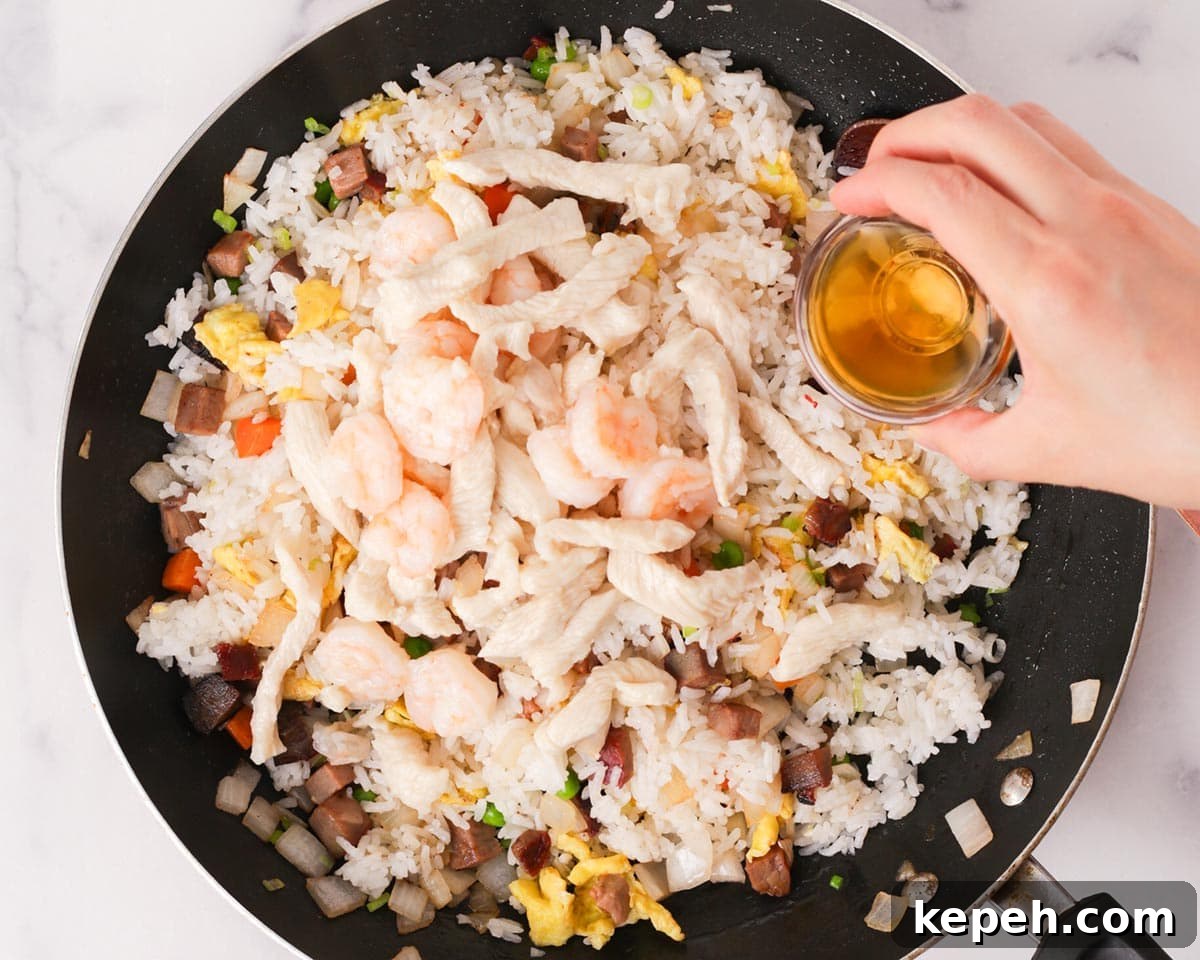 Adding shaoxing rice wine to the pan.