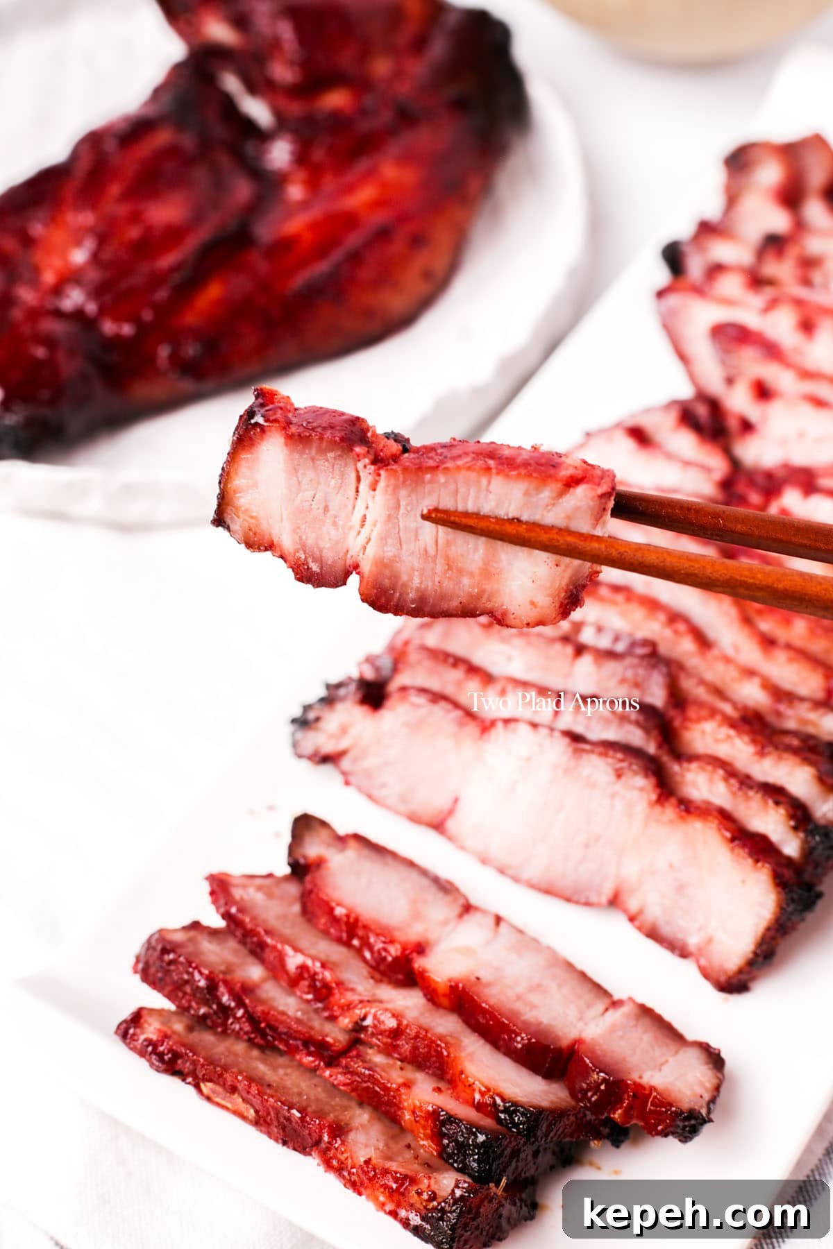 Picking up a slice of char siu.