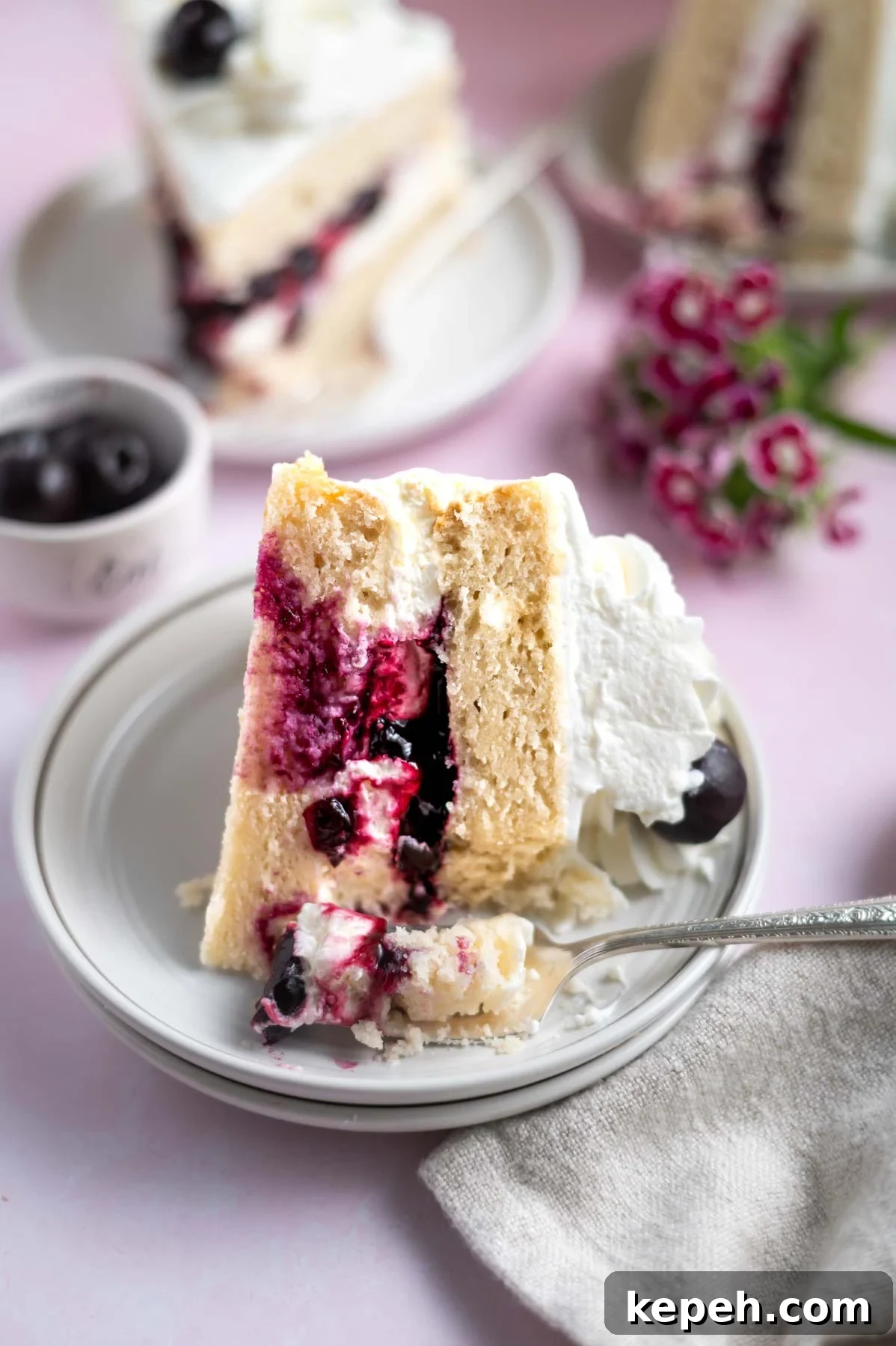 Light and Fluffy White Forest Cake Recipe 2 slices of cake on plates with forks