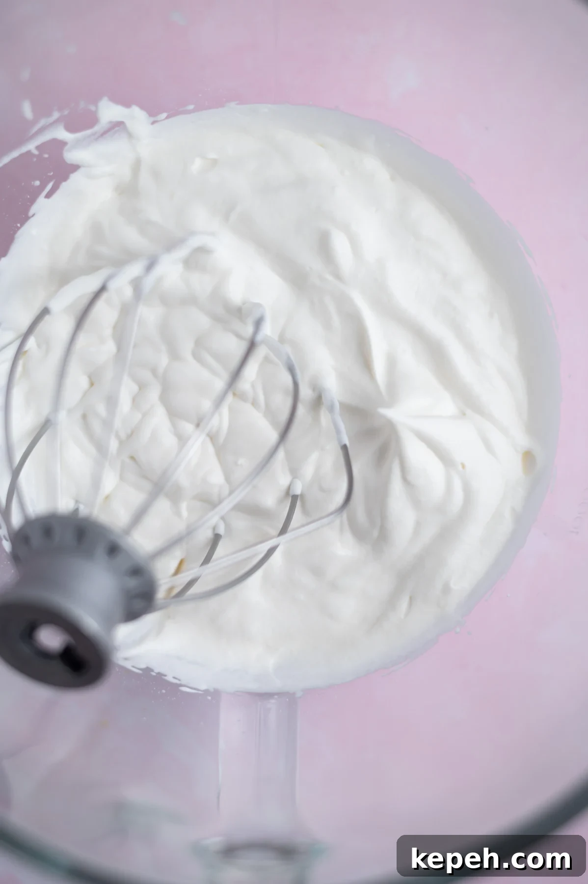 Light and Fluffy White Forest Cake Recipe 13 whipped cream in a mixing bowl with soft peaks