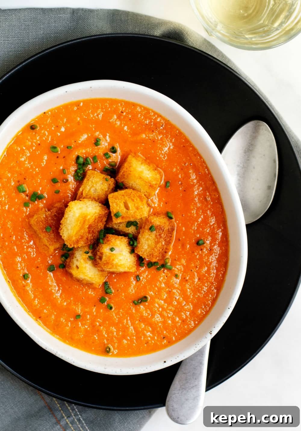 Creamy Tomato Bisque Recipe with Fresh Basil and Croutons 2 Creamy Tomato Bisque served in a white oval bowl
