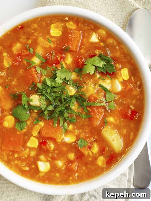 Creamy Tomato Bisque Recipe with Fresh Basil and Croutons 12 Vegan Corn Chowder served in a white bowl