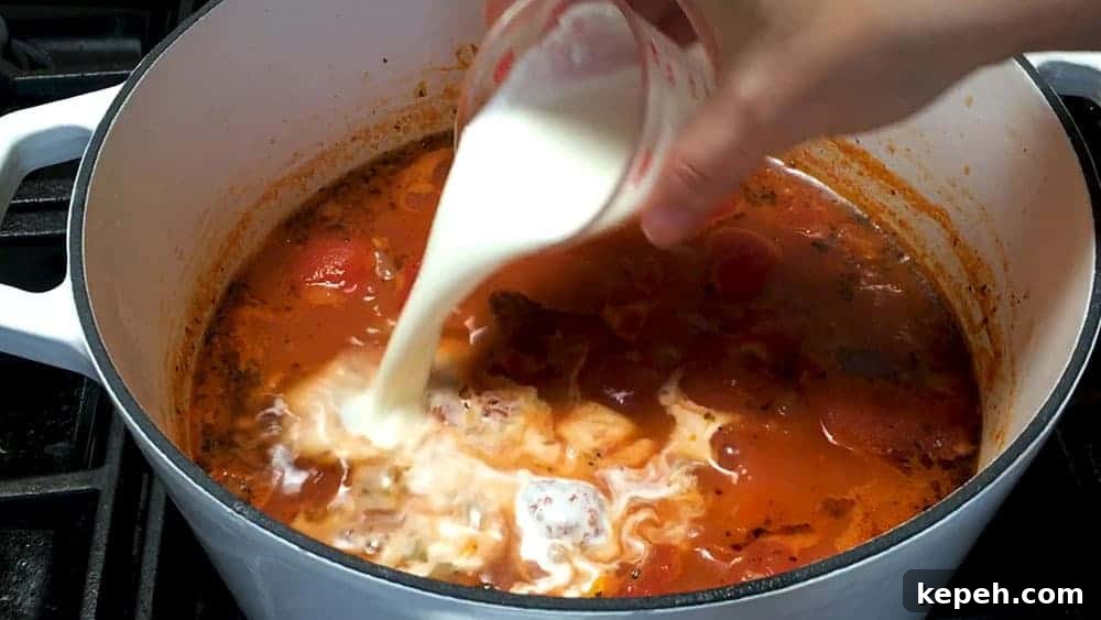 Creamy Tomato Bisque Recipe with Fresh Basil and Croutons 6 Adding cream to tomato bisque