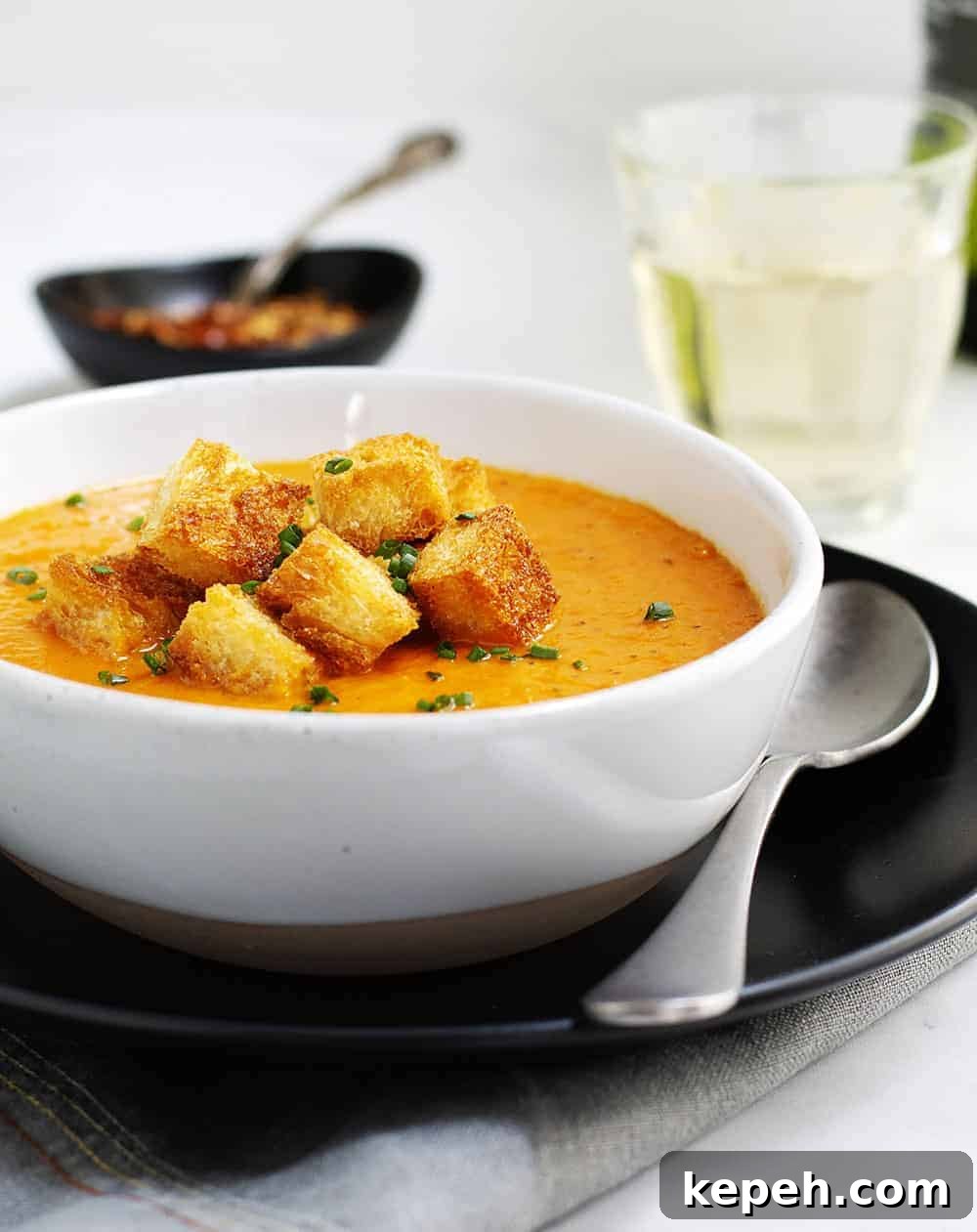 Creamy Tomato Bisque Recipe with Fresh Basil and Croutons 9 Tomato Bisque served in a white bowl