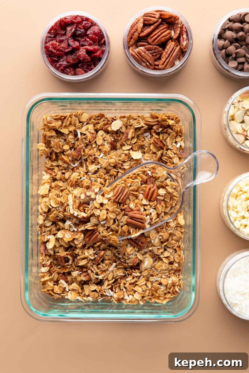 Crunchy Coconut Granola Recipe for Homemade Morning Boost 6 coconut granola in a glass container with bowls of toppings for mixing in