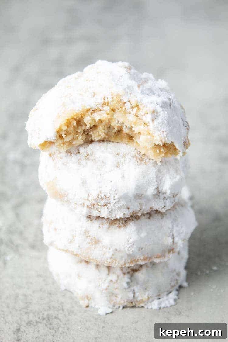 Keto Snickerdoodle Cookies: Low-Carb Cinnamon Treats 14 stack of keto snowballs cookies on countertop