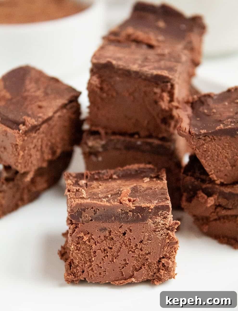 Keto Snickerdoodle Cookies: Low-Carb Cinnamon Treats 25 keto chocolate dessert on a white plate in front of almond milk and cocoa powder in a white bowl