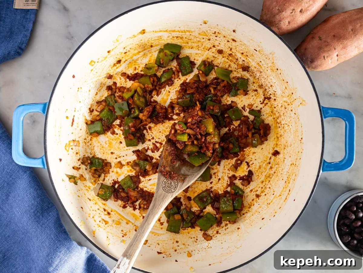 30-Minute Black Bean Chili: Low-Fat, Flavorful Weeknight Recipe 5 Step 1 image – Sautéing onion, bell pepper, garlic, and spices for the black bean chili base.