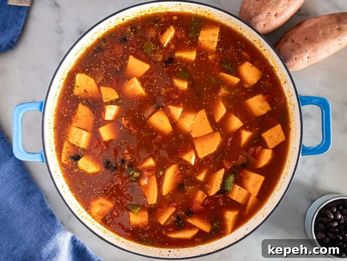 30-Minute Black Bean Chili: Low-Fat, Flavorful Weeknight Recipe 6 Step 2 image – Adding sweet potatoes, tomatoes, and black beans to the pot for black bean chili.