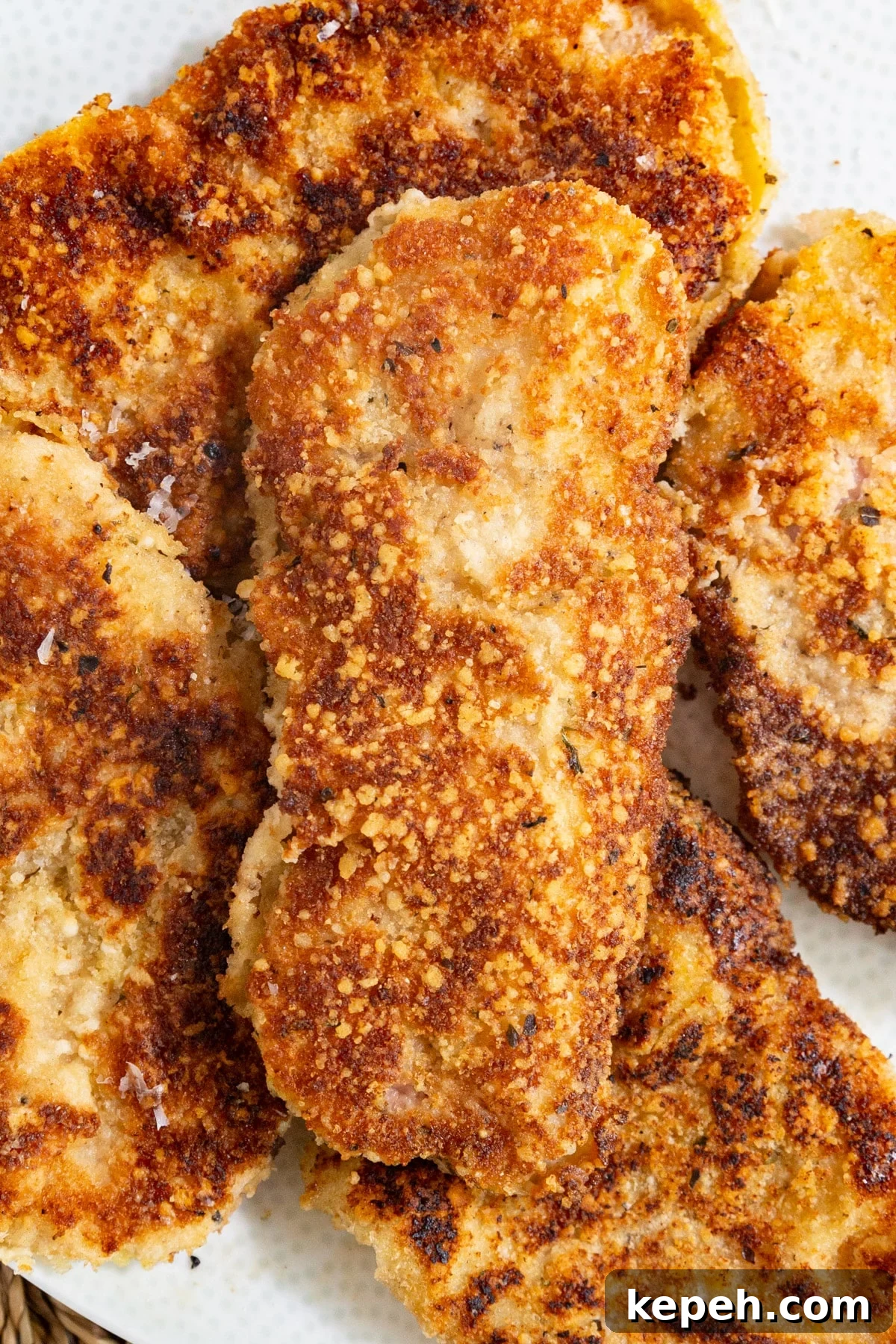 Veal Scallopini with Lemon Butter Sauce Recipe 3 A close up image of a pile of breaded veal cutlets.