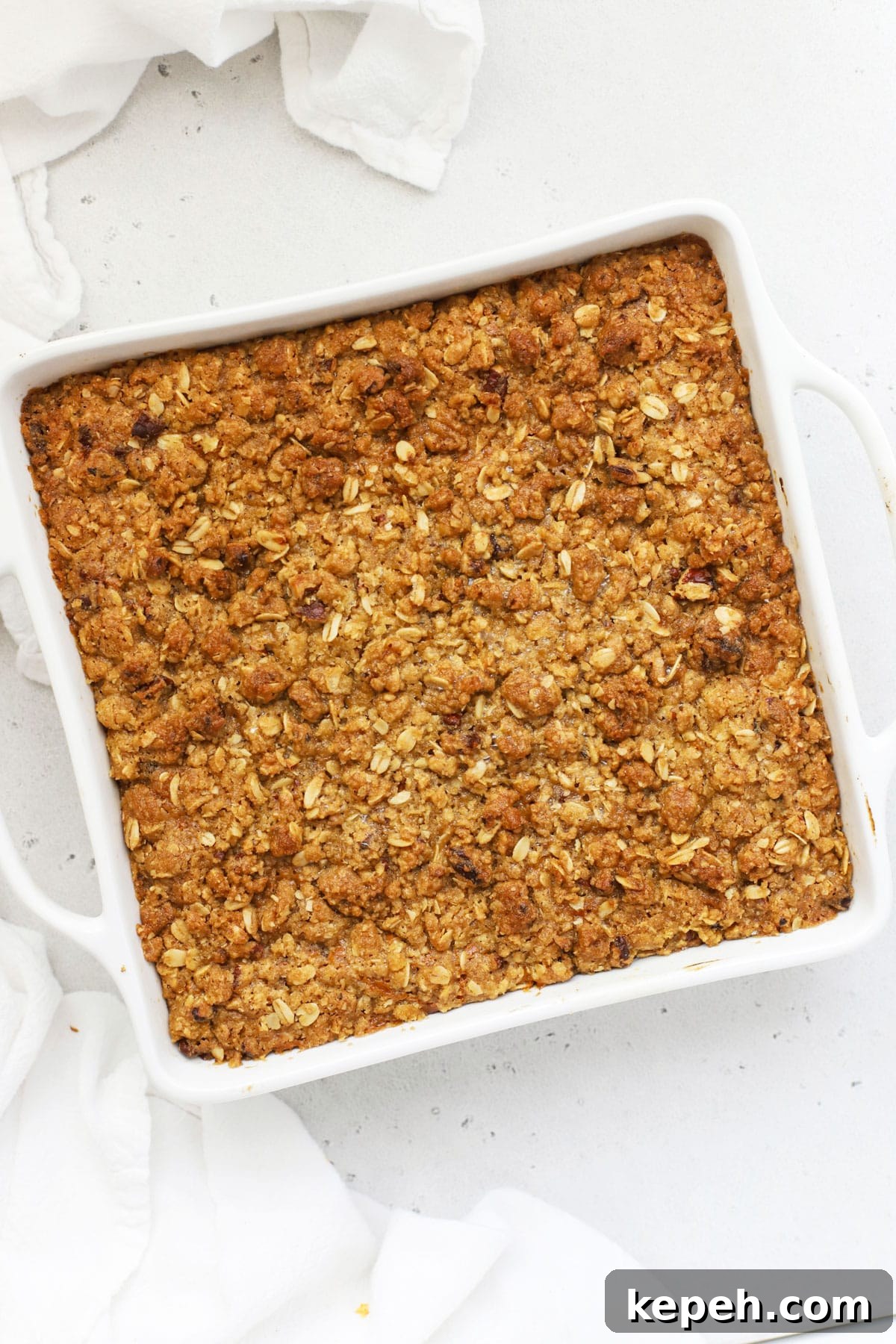 a pan of warm gluten-free pumpkin crisp with oat topping