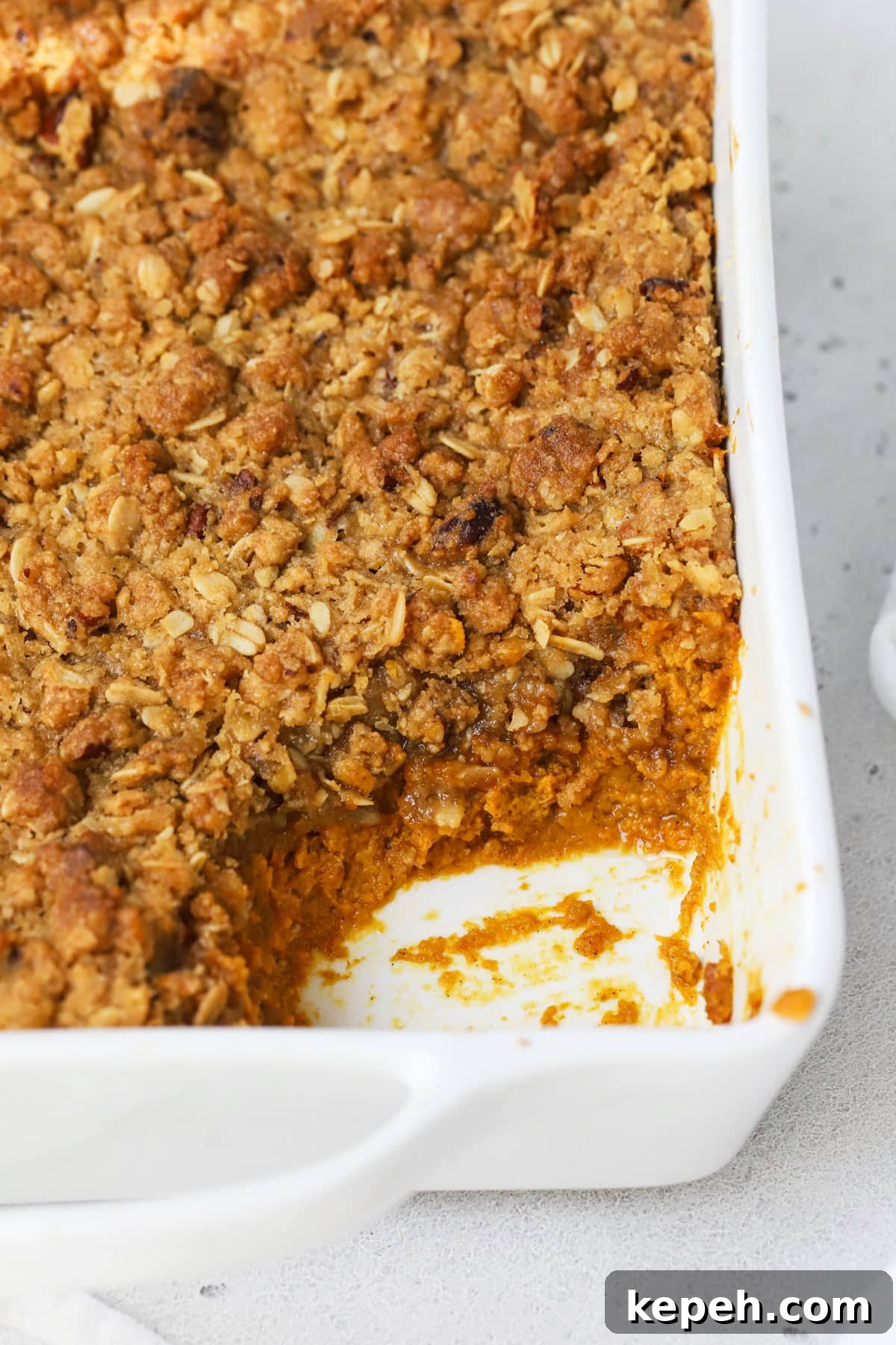 gluten-free pumpkin crisp with a scoop missing