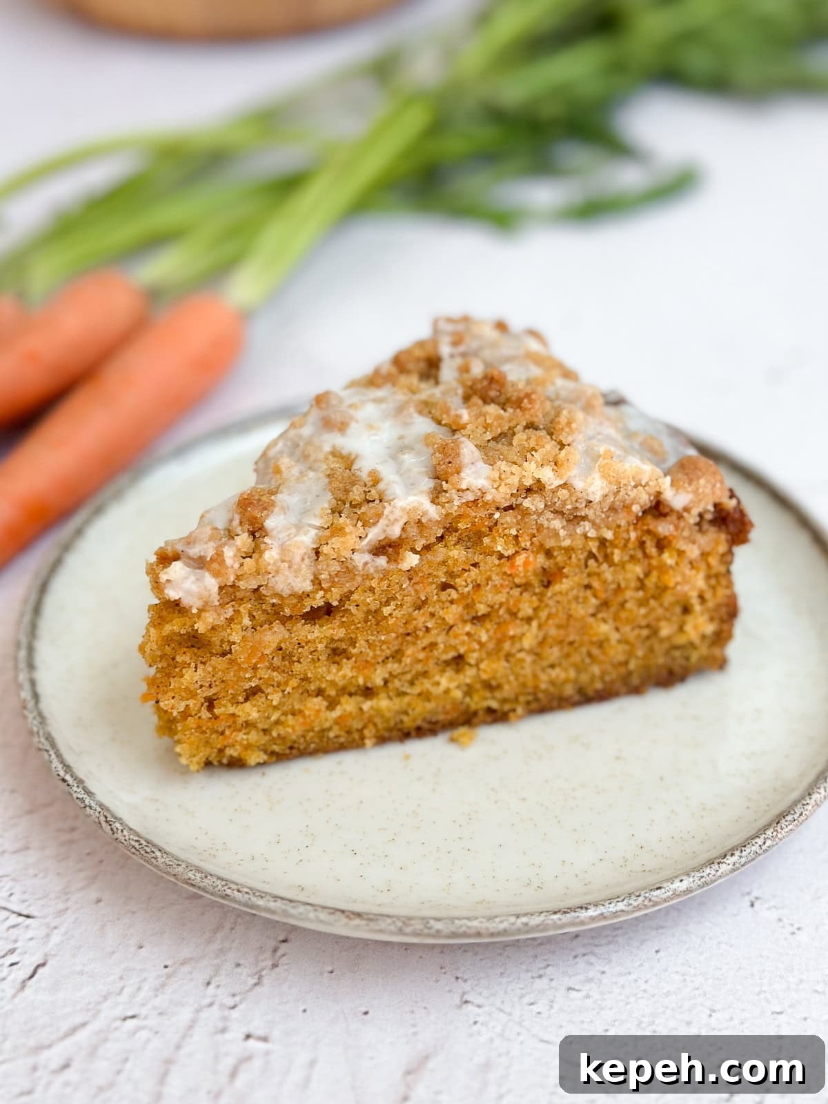 Moist Carrot Coffee Cake with Cream Cheese Glaze 11 a side view of a slice of cake to see the inside texture.