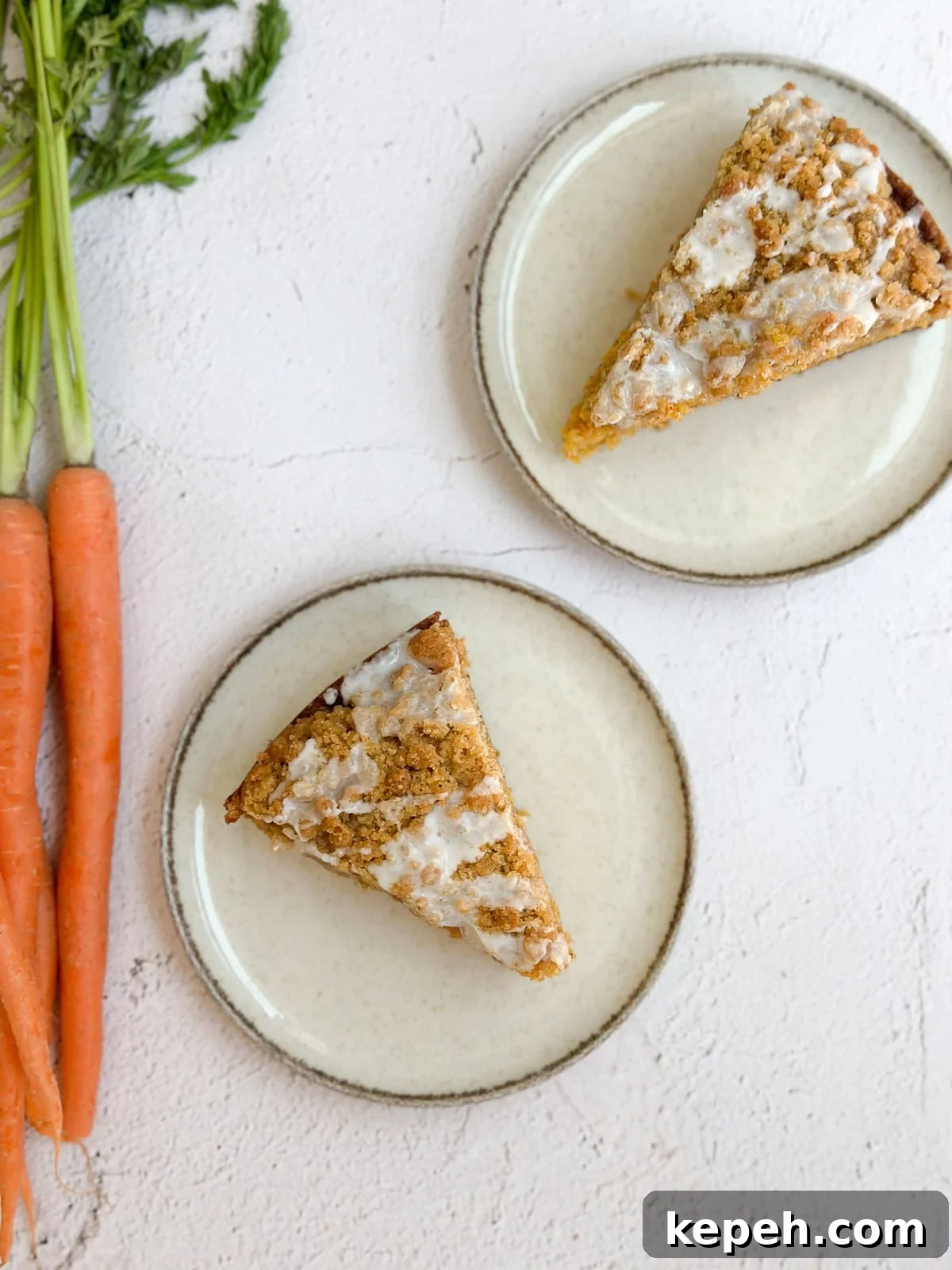 Moist Carrot Coffee Cake with Cream Cheese Glaze 12 two slices of carrot cake coffee cake with some carrots on the side.