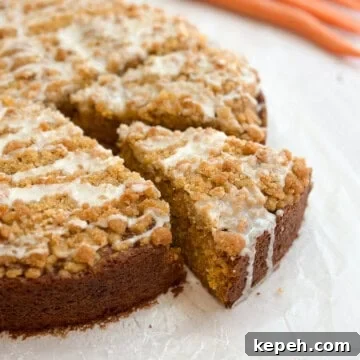 Moist Carrot Coffee Cake with Cream Cheese Glaze 17 a piece of carrot cake coffee cake coming out from the whole cake.
