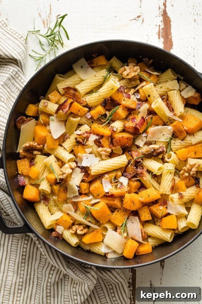 Roasted Butternut Squash Pasta with Sage and Parmesan 2 Roasted butternut squash pasta with rosemary and bacon in a skillet.