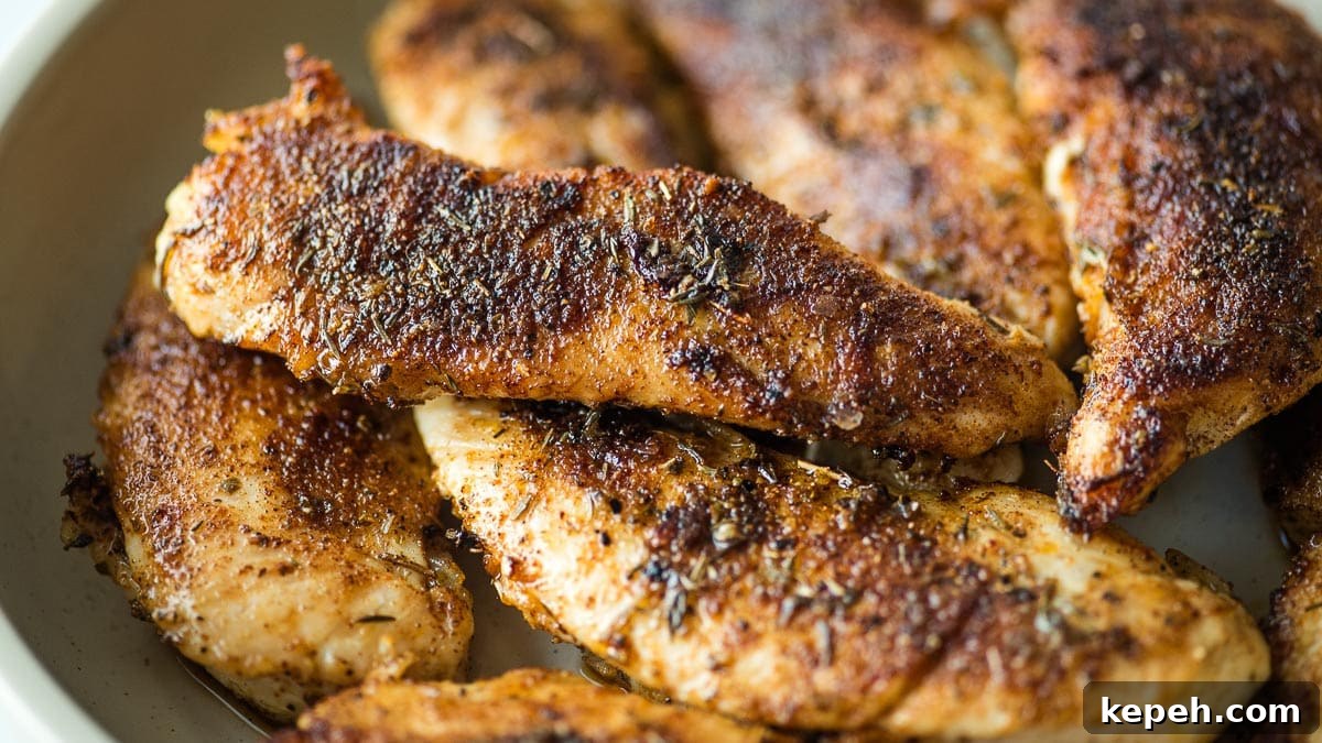 Cajun Blackened Chicken Tenders Recipe with Crispy Pan-Seared Flavor 11 Blackened chicken tenders in a white bowl on a table.