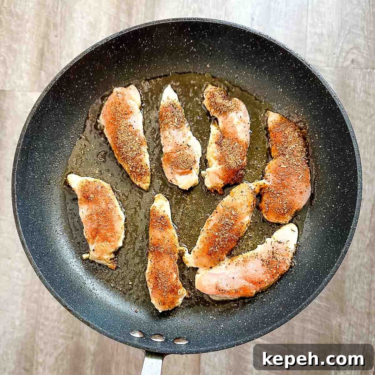 Cajun Blackened Chicken Tenders Recipe with Crispy Pan-Seared Flavor 7 Blackened chicken tenders cooking in a frying pan.
