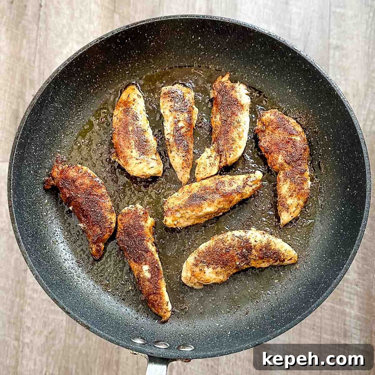 Cajun Blackened Chicken Tenders Recipe with Crispy Pan-Seared Flavor 8 Cooked blackened chicken tenders in a frying pan.