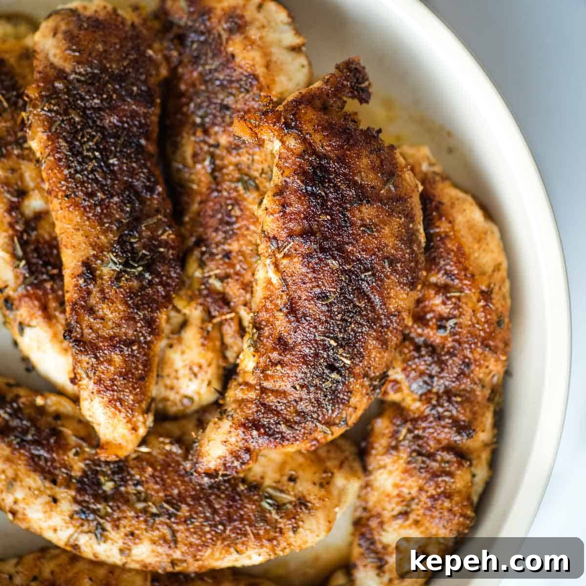 Cajun Blackened Chicken Tenders Recipe with Crispy Pan-Seared Flavor 10 Blackened chicken tenders in a white dish.