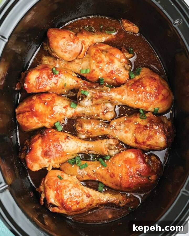Crockpot chicken legs in the pot garnished and ready to serve.