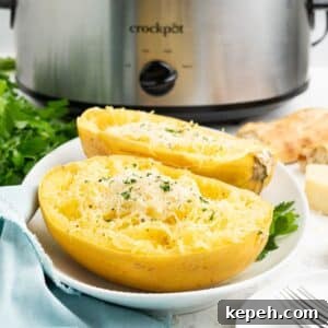 Slow cooker spaghetti squash on a plate topped with parmesan cheese and parsley and a crockpot in the back.
