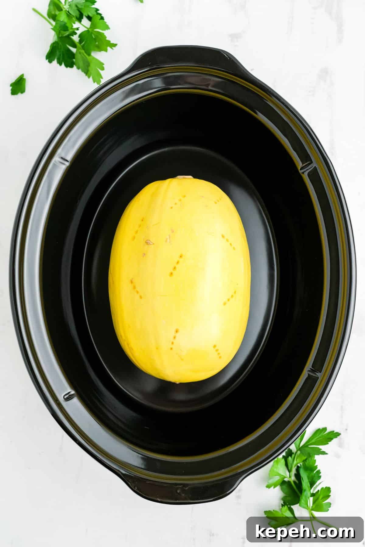 Spaghetti squash in the slow cooker poked with holes.