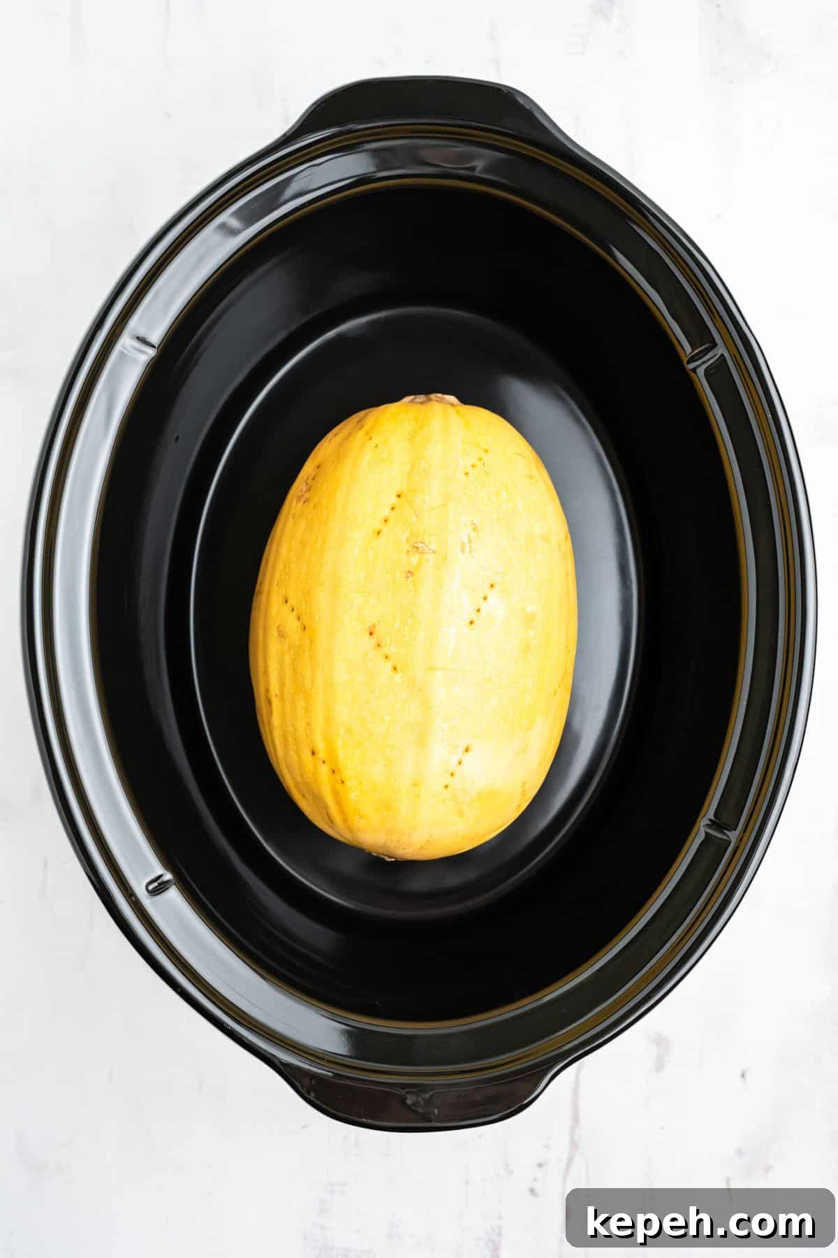 Spaghetti squash in the slow cooker after it's cooked.