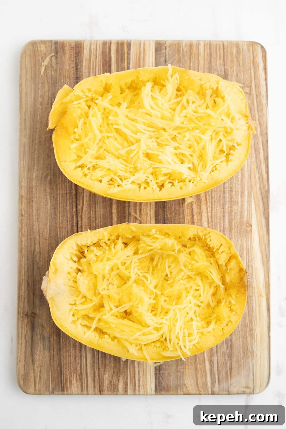 Spaghetti squash with the insides pulled loose into strands of squash.