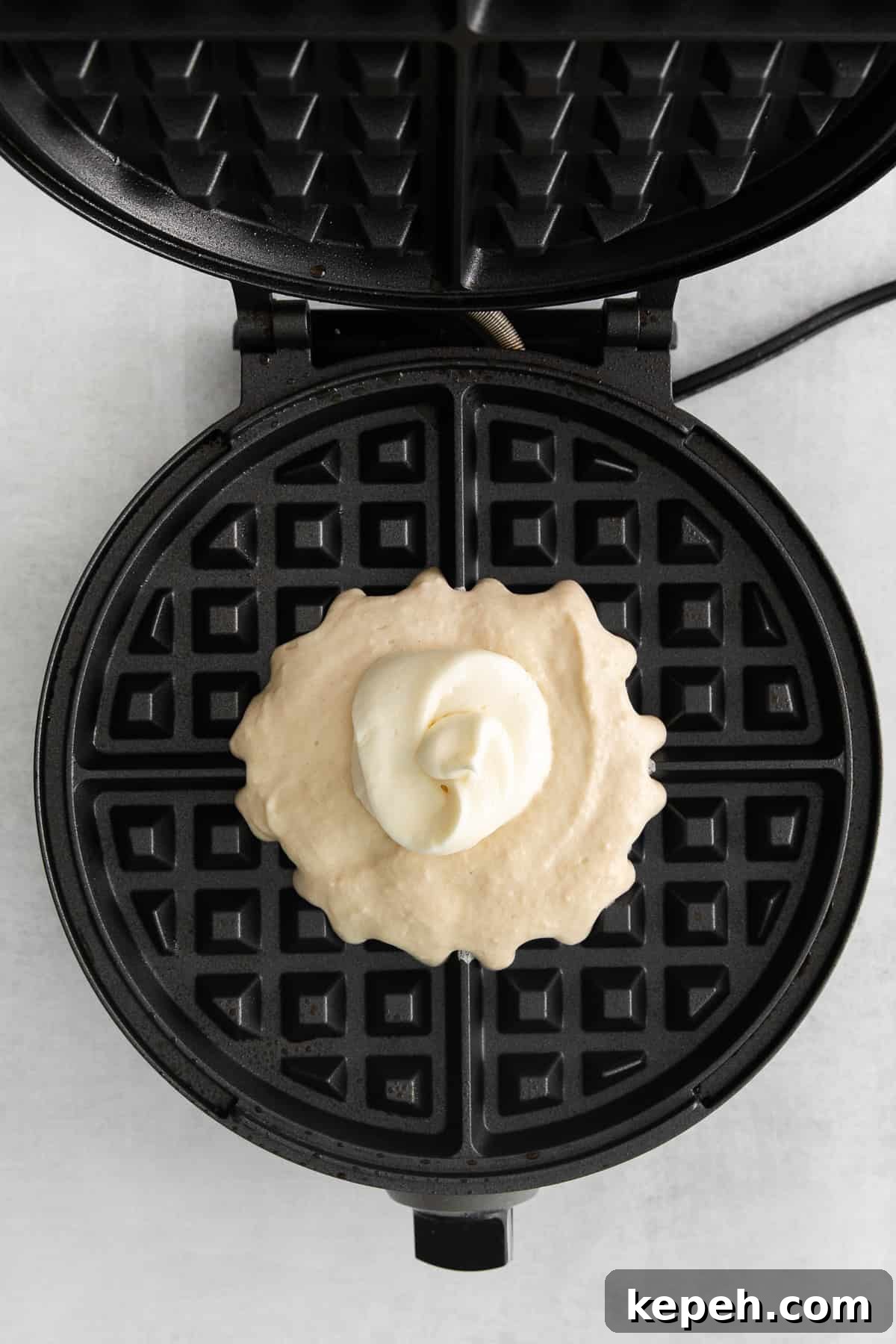 waffle batter in waffle maker.