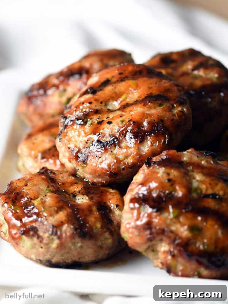 grilled pork sliders piled on white serving plate