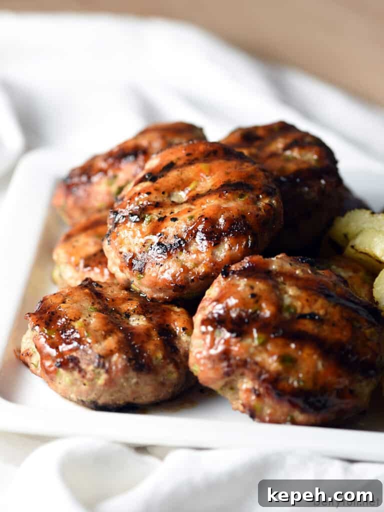 grilled pork sliders piled on white serving plate