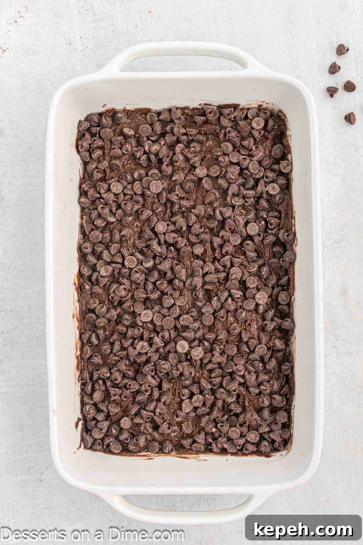 Simple Chocolate Dump Cake Recipe — Quick One-Bowl Dessert 6 Chocolate chips spread on top of cake mix.