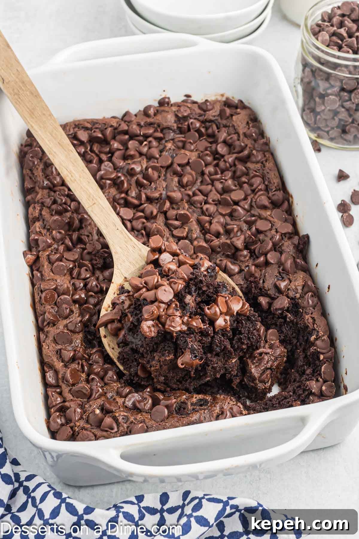 Simple Chocolate Dump Cake Recipe — Quick One-Bowl Dessert 8 Cake being served with a spoon.