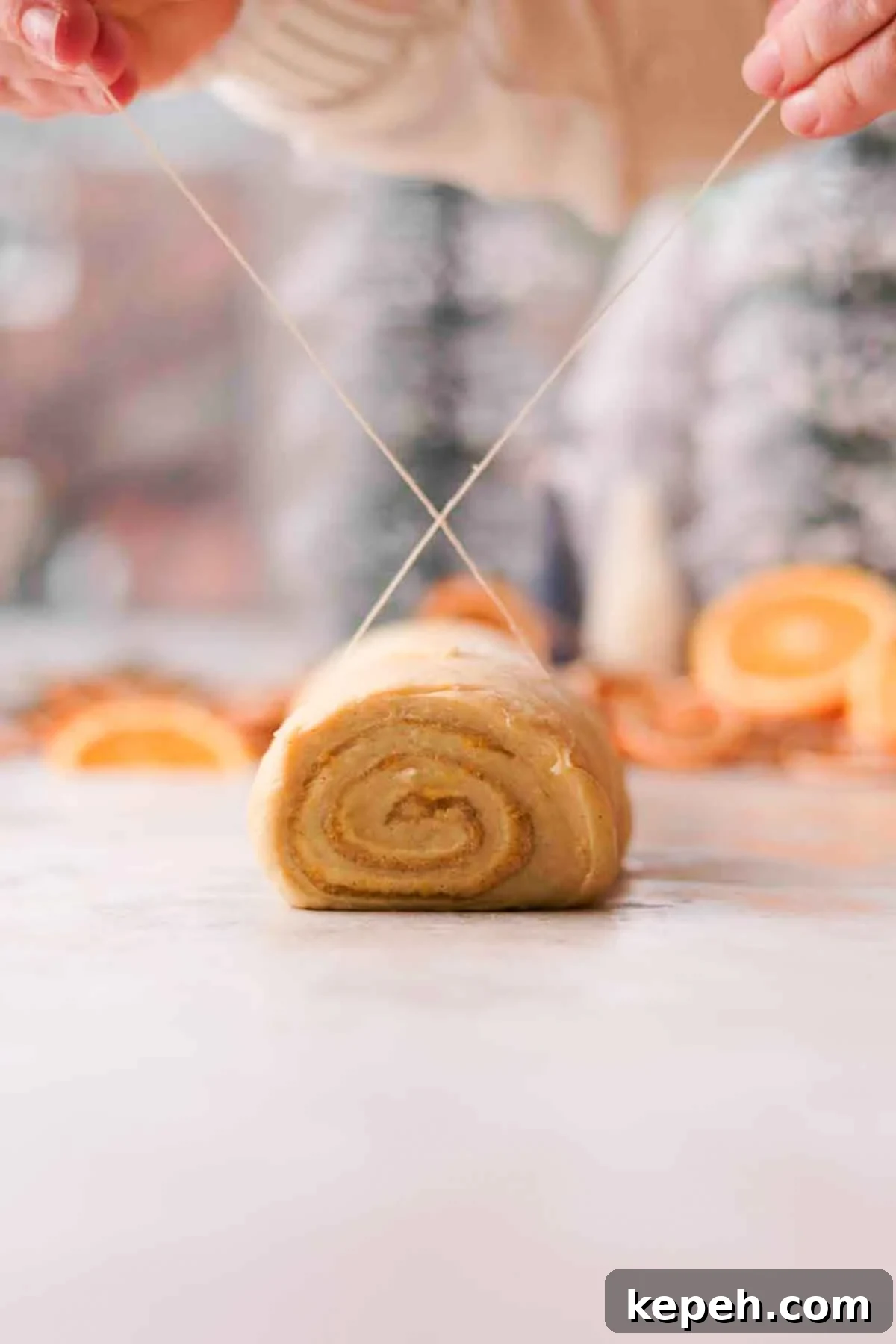cutting orange cinnamon rolls with string
