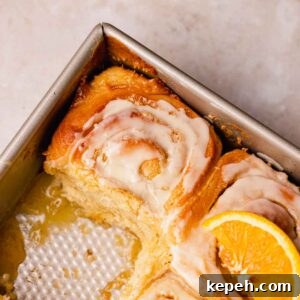 tray of orange cinnamon rolls with 1 missing