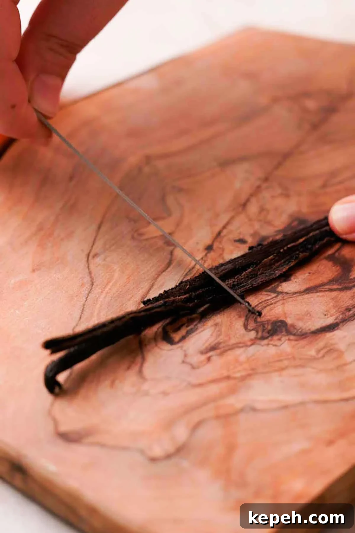 scraping out the seeds from a vanilla bean pod