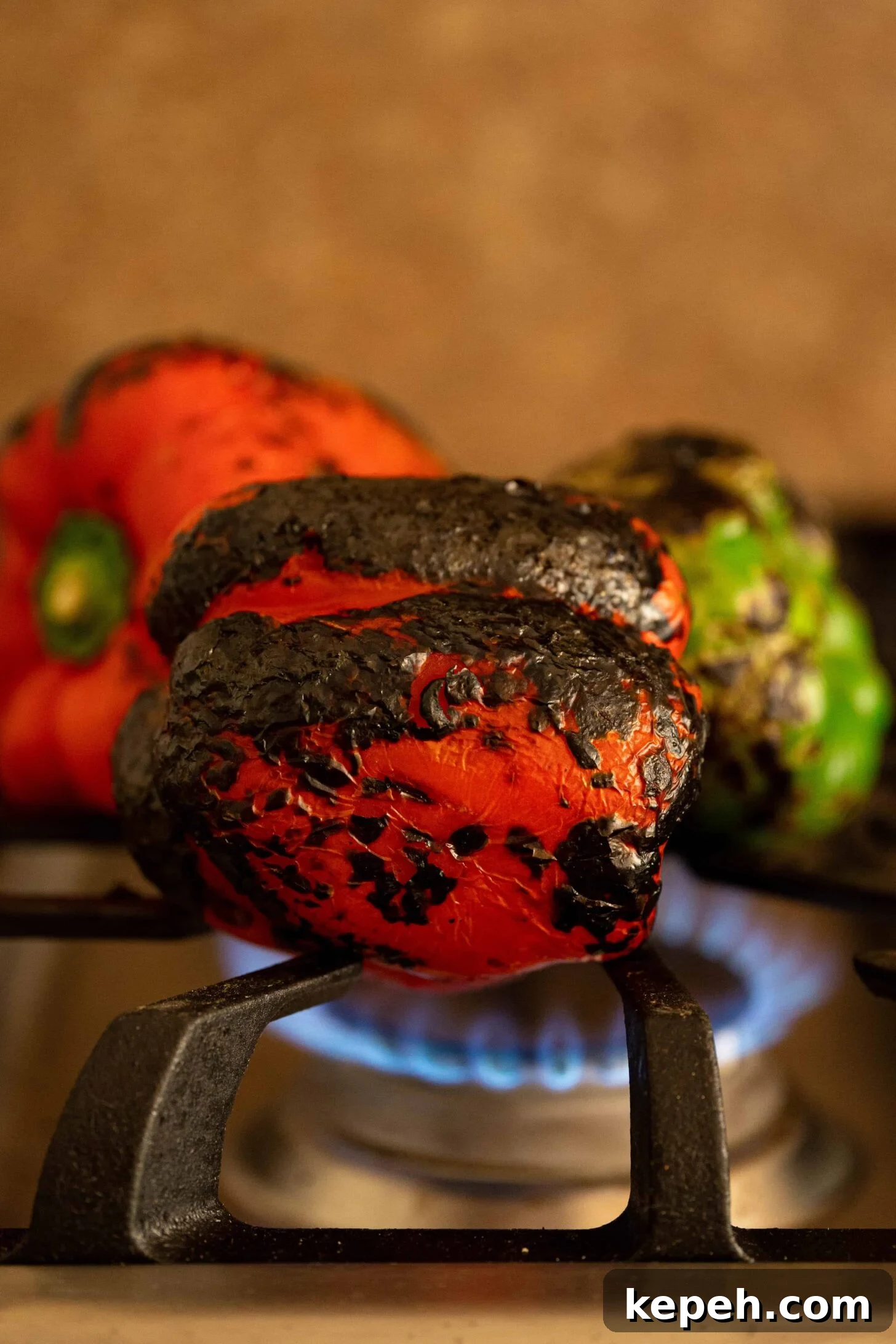 Moroccan Roasted Pepper Salad Recipe with Garlic and Herbs 4 peppers roasting over a flame