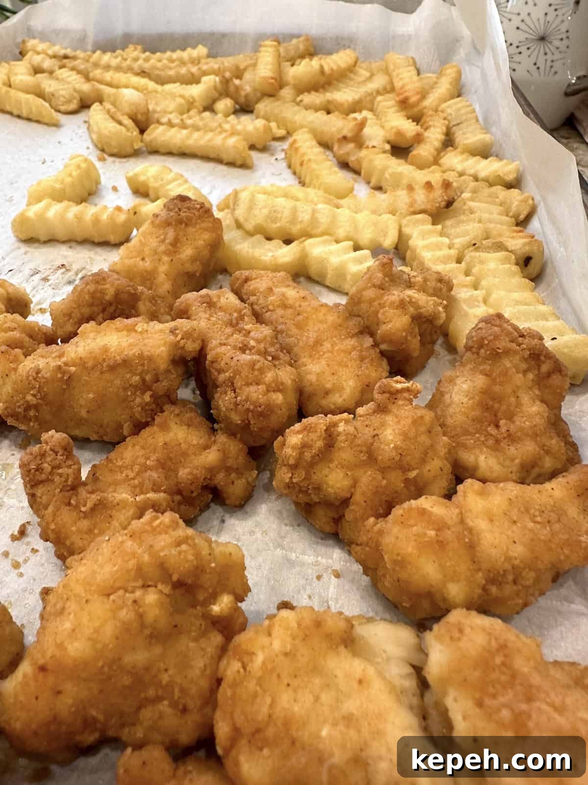 How to Make Authentic French Tacos at Home 5 French fries and chicken nuggets on a baking sheet.