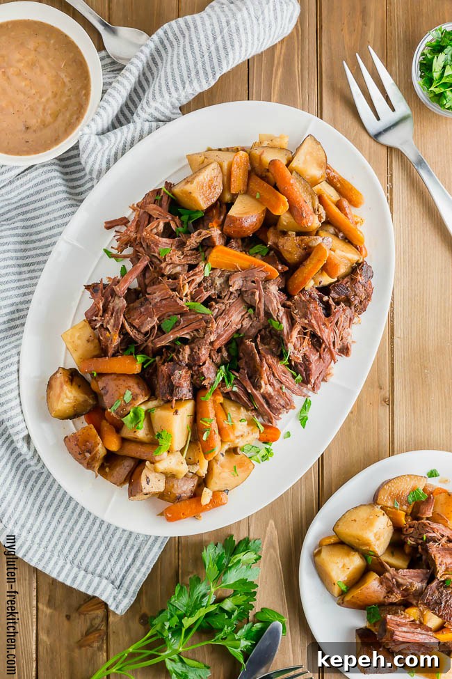 Gluten-free Pot Roast on a platter with a bowl of gravy
