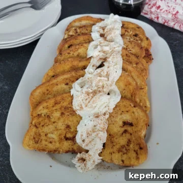Eggnog French Toast Recipe with Video Tutorial 12 EggNog French Toast with eggnog whipped cream on a white platter next to plates