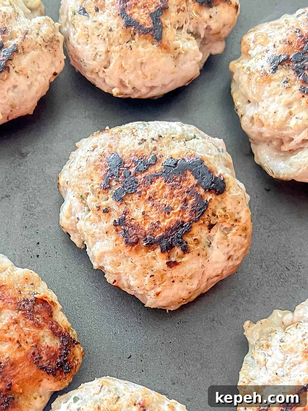 Turkey sausage patties in a pan.