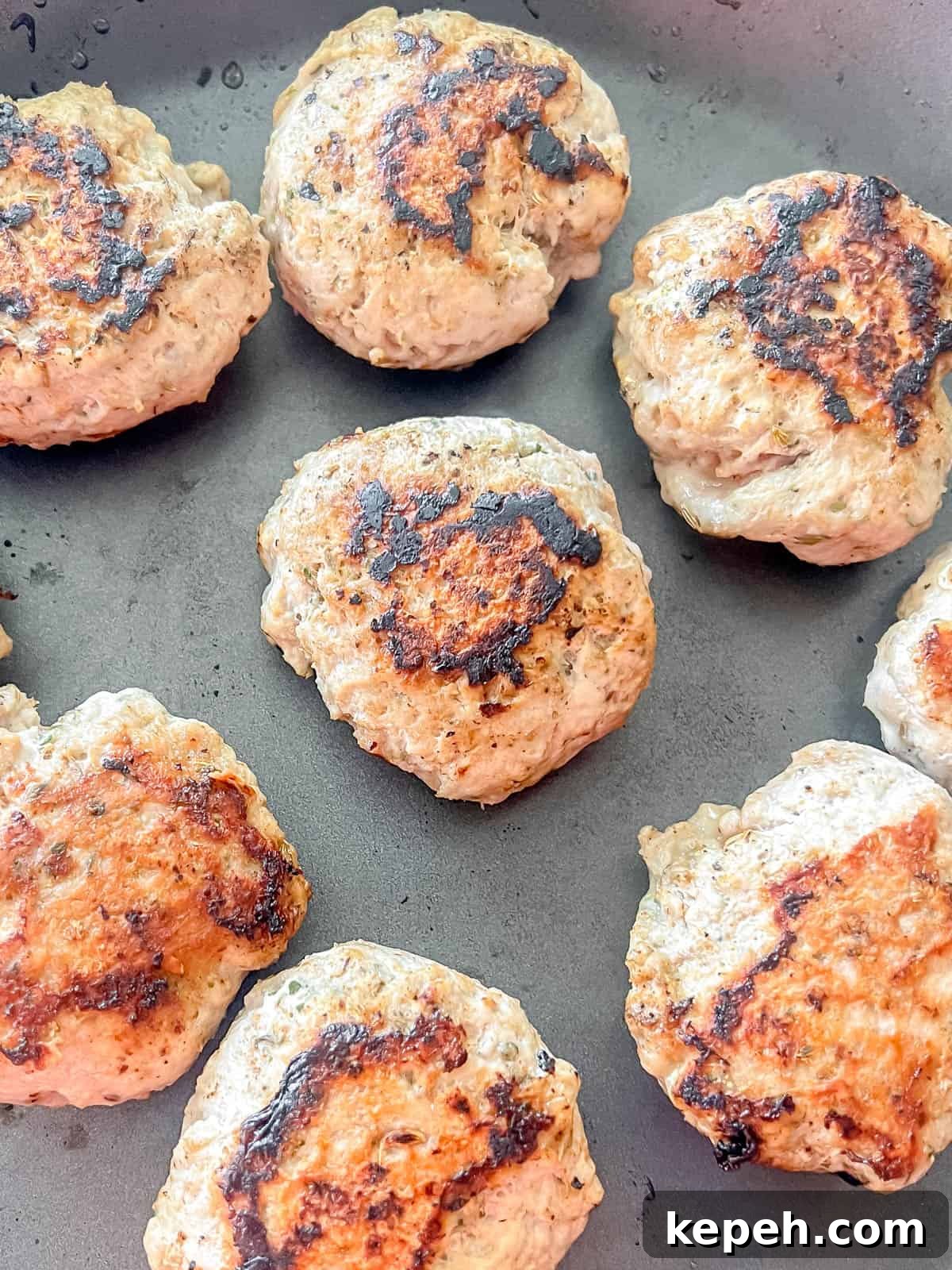 Turkey sausage patties in a pan after cooking.